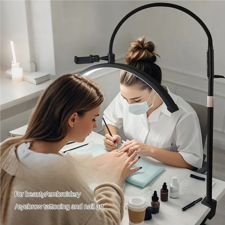 Nail artist working on client's nails in beauty salon