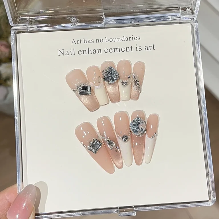 Nude artificial nails with gems in clear box on white